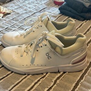 On Running Cream and White Sneakers the Roger